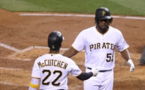 Sep 24, 2016; Pittsburgh, PA, USA; Pittsburgh Pirates center fielder Andrew McCutchen (22) greets right fielder Josh Bell (55) after Bell hit a home run against the Washington Nationals during the third inning at PNC Park. Mandatory Credit: Charles LeClaire-USA TODAY Sports