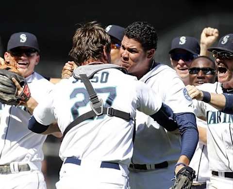 Aug 15, 2012; Seattle, WA, USA; Seattle Mariners pitcher Felix Hernandez (34) embraces catcher John Jaso (27) after the final out of a perfect game against the Tampa Bay Rays at Safeco Field. Mandatory Credit: Joe Nicholson-US PRESSWIRE