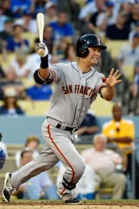 Jun 19, 2015; Los Angeles, CA, USA; San Francisco Giants left fielder Nori Aoki (23) hits a single against the Los Angeles Dodgers during the third inning at Dodger Stadium. Mandatory Credit: Richard Mackson-USA TODAY Sports