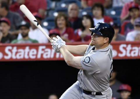 April 22, 2016; Anaheim, CA, USA; Seattle Mariners first baseman Adam Lind (26) hits a sacrifice RBI in the first inning against Los Angeles Angels at Angel Stadium of Anaheim. Mandatory Credit: Richard Mackson-USA TODAY Sports