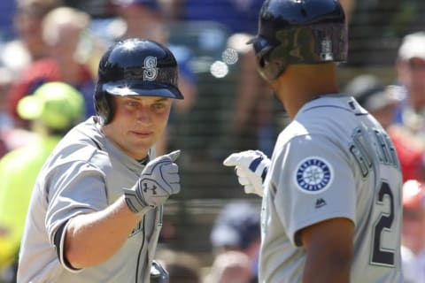 Apr 4, 2016; Arlington, TX, USA; Seattle Mariners third baseman Kyle Seager (15) is congratulated at home plate by left fielder Franklin Gutierrez (21) after hitting a home run in the second inning against the Texas Rangers at Globe Life Park in Arlington. Mandatory Credit: Tim Heitman-USA TODAY Sports