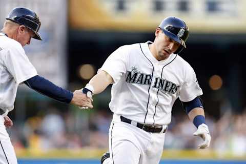 May 28, 2015; Seattle, WA, USA; Seattle Mariners catcher Mike Zunino (3) is greeted by third base coach Rich Donnelly (26) after hitting a solo home run against the Cleveland Indians during the third inning at Safeco Field. Mandatory Credit: Joe Nicholson-USA TODAY Sports