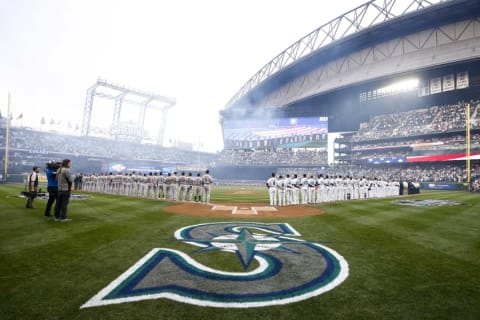 Apr 8, 2016; Seattle, WA, USA; Seattle Mariners and Oakland Athletics coaches, staff and players wait for the national anthem to be performed at Safeco Field. Mandatory Credit: Joe Nicholson-USA TODAY Sports