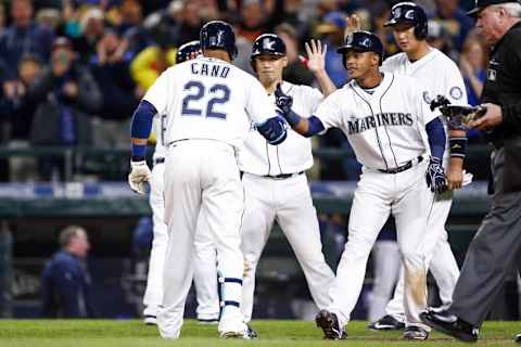 Apr 26, 2016; Seattle, WA, USA; Seattle Mariners second baseman Robinson Cano (22) is greeted by shortstop Ketel Marte (second from right) after hitting a grand-slam homer against the Houston Astros during the seventh inning at Safeco Field. Mandatory Credit: Joe Nicholson-USA TODAY Sports