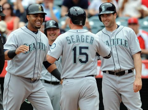 April 24, 2016; Anaheim, CA, USA; Seattle Mariners third baseman Kyle Seager (15) is greeted by designated hitter Nelson Cruz (23) and right fielder Seth Smith (7) hits a three run home run in the first inning against Los Angeles Angels at Angel Stadium of Anaheim. Mandatory Credit: Gary A. Vasquez-USA TODAY Sports