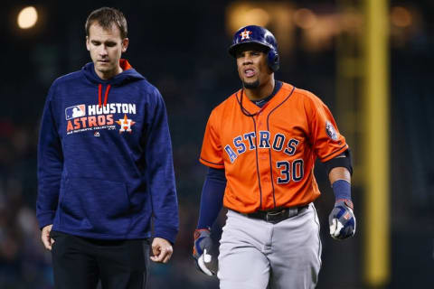 Apr 27, 2016; Seattle, WA, USA; Houston Astros center fielder Carlos Gomez (30) walks back to the dugout with a team staff member after being hit by a pitch against the Seattle Mariners during the fourth inning at Safeco Field. Mandatory Credit: Joe Nicholson-USA TODAY Sports