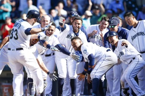 May 11, 2016; Seattle, WA, USA; Seattle Mariners catcher Chris Iannetta (33) is greeted by his teammates following his solo home run against the Tampa Bay Rays during the eleventh inning at Safeco Field. Seattle defeated Tampa Bay 6-5. Mandatory Credit: Joe Nicholson-USA TODAY Sports