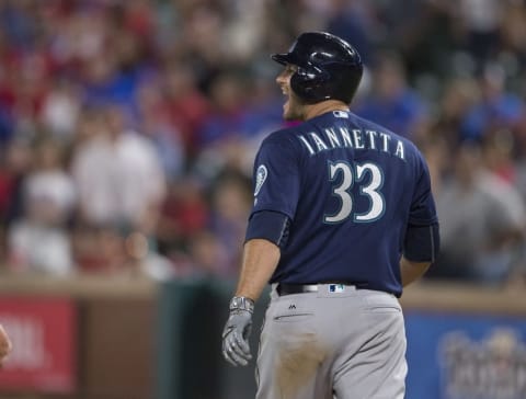 Apr 5, 2016; Arlington, TX, USA; Seattle Mariners catcher Chris Iannetta (33) yells at Texas Rangers relief pitcher Tom Wilhelmsen (not pictured) after being hit by a pitch from Wilhelmsen during the eighth inning at Globe Life Park in Arlington. The Mariners defeated the Rangers 10-2. Mandatory Credit: Jerome Miron-USA TODAY Sports