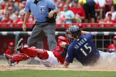 May 22, 2016; Cincinnati, OH, USA; Seattle Mariners third baseman Kyle Seager (15) is tagged out at home by Cincinnati Reds catcher Ramon Cabrera (L) during the fifth inning at Great American Ball Park. Mandatory Credit: David Kohl-USA TODAY Sports