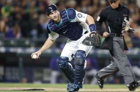 Apr 18, 2015; Seattle, WA, USA; Seattle Mariners catcher Mike Zunino (3) fields a ball during the eighth inning against the Texas Rangers at Safeco Field. Mandatory Credit: Jennifer Buchanan-USA TODAY Sports