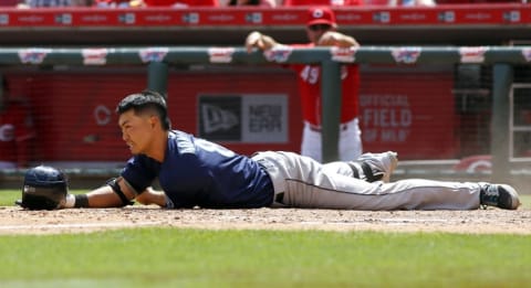 May 22, 2016; Cincinnati, OH, USA; Seattle Mariners left fielder Norichika Aoki goes down while bunting during the ninth inning against the Cincinnati Reds at Great American Ball Park. The Mariners won 5-4. Mandatory Credit: David Kohl-USA TODAY Sports