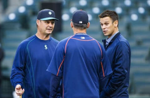 Apr 25, 2016; Seattle, WA, USA; Seattle Mariners manager Scott Servais (9, left) and general manager Jerry Dipoto talk with a member of the Houston Astros during batting practice at Safeco Field. Mandatory Credit: Joe Nicholson-USA TODAY Sports