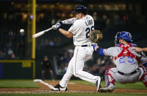 Sep 7, 2016; Seattle, WA, USA; Seattle Mariners first baseman Adam Lind (26) hits a grand slam against the Texas Rangers during the first inning at Safeco Field. Mandatory Credit: Joe Nicholson-USA TODAY Sports