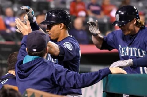 Sep 12, 2016; Anaheim, CA, USA; Seattle Mariners center fielder Leonys Martin (let) and left fielder Ben Gamel (16) get high-fives as they return to the dugout after scoring on Gamel’s 2-run home run in the 8th inning against the Los Angeles Angels at Angel Stadium of Anaheim. Mandatory Credit: Robert Hanashiro-USA TODAY Sports