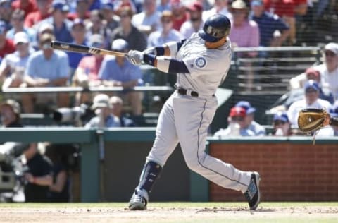 Apr 4, 2016; Arlington, TX, USA; Seattle Mariners second baseman Robinson Cano (22) hits a home run in the first inning against the Texas Rangers at Globe Life Park in Arlington. Mandatory Credit: Tim Heitman-USA TODAY Sports