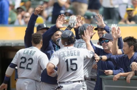 May 4, 2016; Oakland, CA, USA; Seattle Mariners first baseman Dae-Ho Lee (10) is congratulated by third baseman Kyle Seager (15) and second baseman Robinson Cano (22) and teammates after hitting a two-run home run against the Oakland Athletics in the seventh inning at the Oakland Coliseum. The Seattle Mariners won 9-8. Mandatory Credit: Neville E. Guard-USA TODAY Sports