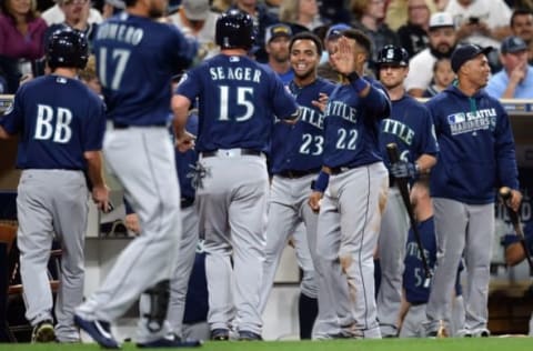 Jun 2, 2016; San Diego, CA, USA; Seattle Mariners third baseman Kyle Seager (15) celebrates with teammates after scoring a run during the seventh inning against the San Diego Padres at Petco Park. Mandatory Credit: Jake Roth-USA TODAY Sports