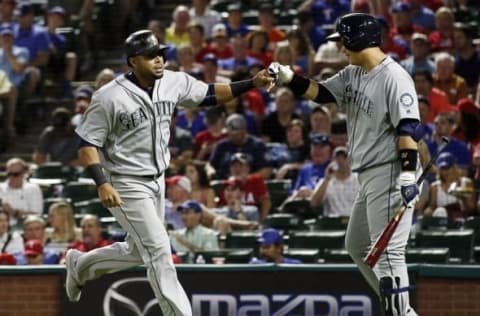 Jun 4, 2016; Arlington, TX, USA; Seattle Mariners designated hitter Nelson Cruz (23) is greeted at the plate by first baseman Dae-Ho Lee (10) after hitting a solo Home run in the third inning against the Texas Rangers at Globe Life Park in Arlington. Mandatory Credit: Ray Carlin-USA TODAY Sports