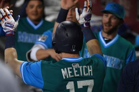 PHOENIX, AZ – AUGUST 24: Mitch Haniger #17 of the Seattle Mariners celebrates with teammates in the dugout after hitting a solo home run against the Arizona Diamondbacks during the fifth inning at Chase Field on August 24, 2018 in Phoenix, Arizona. The players are wearing special jerseys as part of MLB Players Weekend. (Photo by Norm Hall/Getty Images)