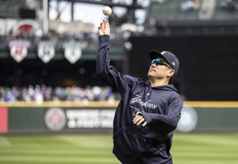 Masahiro Tanaka #19 of the New York Yankees throws a ball to a fan before a game against the Seattle Mariners at Safeco Field on September 9, 2018 in Seattle, Washington. The Mariners won 3-2. (Photo by Stephen Brashear/Getty Images)