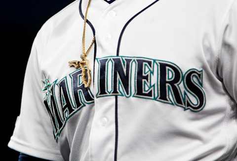 SEATTLE, WA – APRIL 02: A gold Florida necklace sits over the Seattle Mariners logo. Kyle Lewis, Jarred Kelenic, Julio Rodriguez jersey choice.  (Photo by Lindsey Wasson/Getty Images)