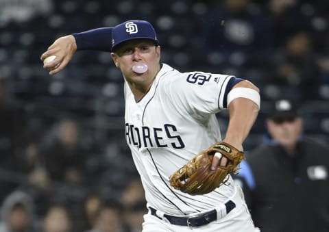 SAN DIEGO, CA – MAY 21: Ty France #11 of the San Diego Padres blows a bubble as he throws out Blake Swihart #19 of the Arizona Diamondbacks during the sixth inning of a baseball game at Petco Park May 21, 2019 in San Diego, California. (Photo by Denis Poroy/Getty Images)