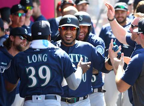 ANAHEIM, CA – JUNE 09: Edwin Encarnacion #10 is congratulated by Shed Long #39 and Domingo Santana #16 of the Seattle Mariners in the dugout Domingo Santana #16 of the Seattle Mariners after hitting a two run home run, his second of the game and 400th in his career, in the sixth inning against the Los Angeles Angels at Angel Stadium of Anaheim on June 9, 2019 in Anaheim, California. (Photo by Jayne Kamin-Oncea/Getty Images)