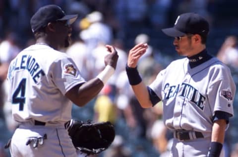 Seattle Mariners players Mark McLemore (L) and Ichiro Suzuki (R) celebrate after winning against the Anaheim Angels 5-3 in Anaheim, CA, 30 June 2001. AFP PHOTO/Lucy Nicholson (Photo by LUCY NICHOLSON / AFP) (Photo credit should read LUCY NICHOLSON/AFP via Getty Images)