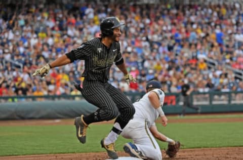 OMAHA, NE – JUNE 25: Austin Martin #16 of the Vanderbilt Commodores gets thrown out at first base in the third inning against the Michigan Wolverines during game two of the College World Series Championship Series on June 25, 2019, at TD Ameritrade Park Omaha in Omaha, Nebraska. (Photo by Peter Aiken/Getty Images)