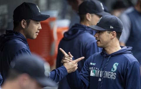 SEATTLE, WA – JULY 23: Yusei Kikuchi of the Seattle Mariners greets teammate Marco Gonzales in the dugout. (Photo by Stephen Brashear/Getty Images)