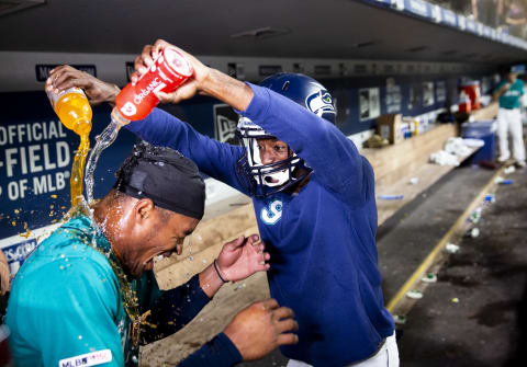 SEATTLE, WA – JULY 26: Mallex Smith #0 of the Seattle Mariners is doused in Gatorade by teammate Dee Gordon, wearing a Seahawks helmet, after Smith hit a walk-off single against the Detroit Tigers at T-Mobile Park on July 26, 2019 in Seattle, Washington. The Mariners beat the Tigers 3-2. (Photo by Lindsey Wasson/Getty Images)