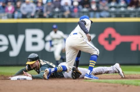 SEATTLE, WA – SEPTEMBER 29: Seth Brown #65 of the Oakland Athletics steals second base before second baseman Dee Gordon #9 of the Seattle Mariners can make a tag during the second inning of a game at T-Mobile Park on September 29, 2019 in Seattle, Washington. (Photo by Stephen Brashear/Getty Images)