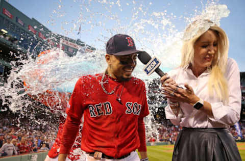 BOSTON, MASSACHUSETTS – SEPTEMBER 29: Mookie Betts #50 of the Boston Red Sox and NESN host Guerin Austin are doused in Gatorade after Betts scored the game-winning run to defeat Baltimore Orioles 5-4 at Fenway Park on September 29, 2019, in Boston, Massachusetts. (Photo by Maddie Meyer/Getty Images)