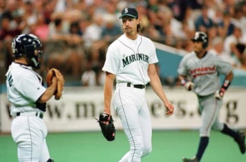 Seattle Mariner pitcher Randy Johnson (C) gets encouragement from his catcher John Marzano (L) after Cleveland Indian Manny Ramirez (R) rounds the bases after his three-run home run during the sixth inning of play on 28 July in Seattle, WA. Johnson gave up only 4 hits, but two were home runs as Cleveland beat Seattle 4-3. AFP PHOTO Dan Levine (Photo by DAN LEVINE / AFP) (Photo by DAN LEVINE/AFP via Getty Images)