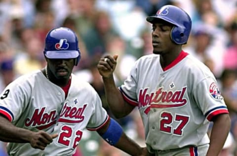 Montreal Expos outfielder Rondell White (#22) congratulates Vladimir Guerrero (#27) for a fifth inning homer against the Chicago Cubs 16 June 2000 in Chicago. AFP Photo/Tannen MAURY (Photo by TANNEN MAURY / AFP) (Photo by TANNEN MAURY/AFP via Getty Images)