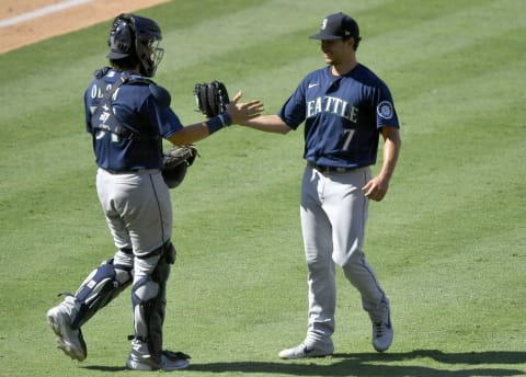 ANAHEIM, CA – AUGUST 31: Joseph Odom of the Seattle Mariners congratulates Marco Gonzales after throwing a complete game. (Photo by John McCoy/Getty Images)