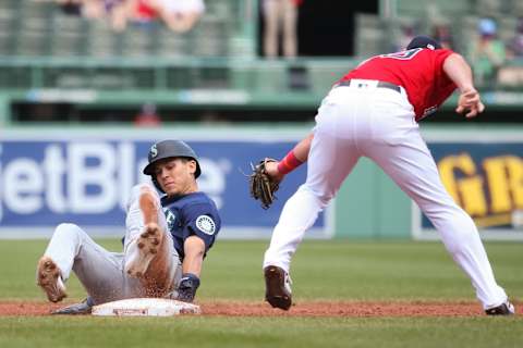 BOSTON, MA – APRIL 24: Sam Haggerty #0 of the Seattle Mariners safely avoids a tag out by Christian Arroyo #39 of the Boston Red Sox. (Photo by Kathryn Riley/Getty Images)