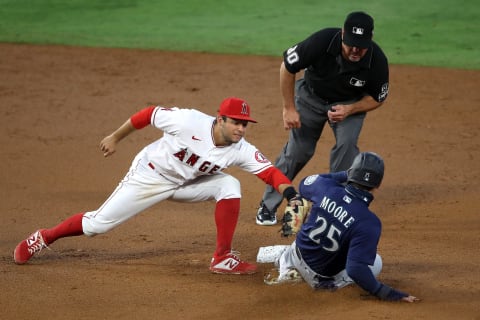 ANAHEIM, CALIFORNIA – JULY 29: Tommy La Stella #9 of the Los Angeles Angels tags out Dylan Moore #25 of the Seattle Mariners attempting to steal second base as umpire Rob Drake #30 makes the ball during the third inning of a game at Angel Stadium of Anaheim on July 29, 2020 in Anaheim, California. (Photo by Sean M. Haffey/Getty Images)