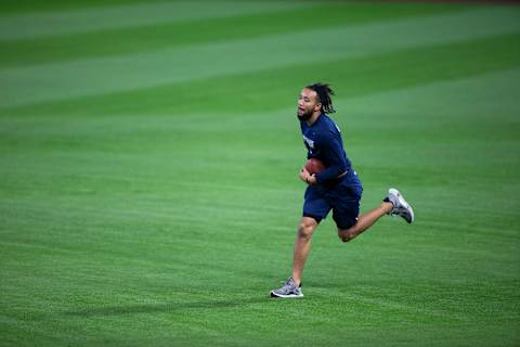 SEATTLE, WA – AUGUST 06: J.P. Crawford #3 of the Seattle Mariners catches a football as he tosses it with teammates before the game against the Los Angeles Angels at T-Mobile Park on August 6, 2020 in Seattle, Washington. The Angels beat the Mariners 6-1. (Photo by Lindsey Wasson/Getty Images)