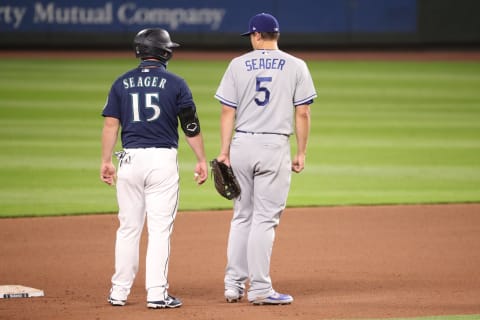 SEATTLE, WASHINGTON – AUGUST 19: Brothers Kyle Seager #15 of the Seattle Mariners and Corey Seager #5 of the Los Angeles Dodgers have a conversation at second base in the seventh inning at T-Mobile Park on August 19, 2020 in Seattle, Washington. (Photo by Abbie Parr/Getty Images)