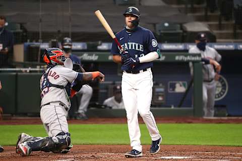 SEATTLE, WASHINGTON – SEPTEMBER 21: Evan White #12 of the Seattle Mariners reacts after striking out in the third inning against the Houston Astros at T-Mobile Park on September 21, 2020 in Seattle, Washington. (Photo by Abbie Parr/Getty Images)