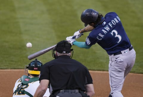 OAKLAND, CALIFORNIA – SEPTEMBER 25: J.P. Crawford, Gold Glover winner of the Seattle Mariners hits a base hit. (Photo by Thearon W. Henderson/Getty Images)