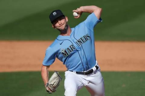 PEORIA, ARIZONA – MARCH 09: Pitcher Ian McKinney #75 of the Seattle Mariners throws against the Kansas City Royals. (Photo by Ralph Freso/Getty Images)