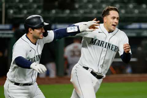 SEATTLE, WASHINGTON – APRIL 01: Luis Torrens and Evan White of the Mariners react after a walk-off win over the Giants. (Photo by Steph Chambers/Getty Images)