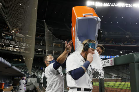 SEATTLE, WASHINGTON – APRIL 01: Jake Fraley of the Seattle Mariners is doused with a water cooler. (Photo by Steph Chambers/Getty Images)