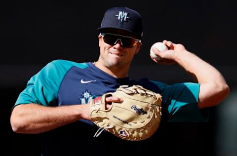 SEATTLE, WASHINGTON – MAY 04: Evan White #12 of the Seattle Mariners warms up before the game against the Baltimore Orioles. (Photo by Steph Chambers/Getty Images)