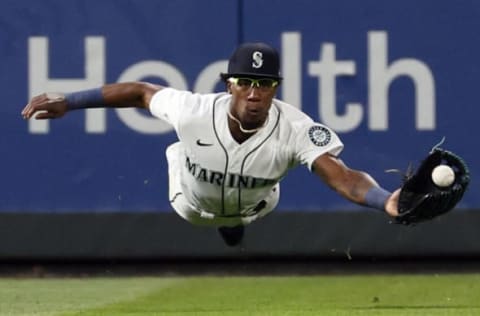 SEATTLE, WASHINGTON – JULY 07: Shed Long Jr. #4 of the Seattle Mariners dives for the ball, but comes up short, during the seventh inning against the New York Yankees at T-Mobile Park on July 07, 2021 in Seattle, Washington. (Photo by Steph Chambers/Getty Images)