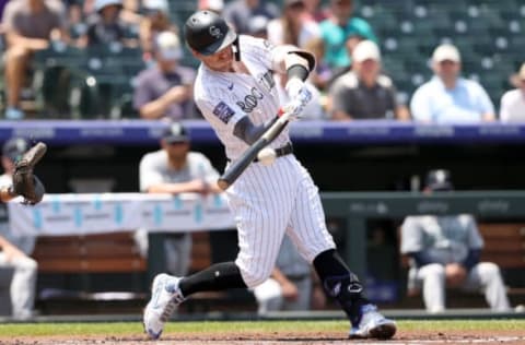 DENVER, COLORADO – JULY 21: Trevor Story #27 of the Colorado Rockies hits a single against the Seattle Mariners in the first inning at Coors Field on July 21, 2021 in Denver, Colorado. (Photo by Matthew Stockman/Getty Images)