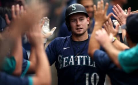 Jarred Kelenic of the Seattle Mariners high-fives teammates in the dugout after hitting a home run against the Los Angeles Angels. (Photo by Katharine Lotze/Getty Images)