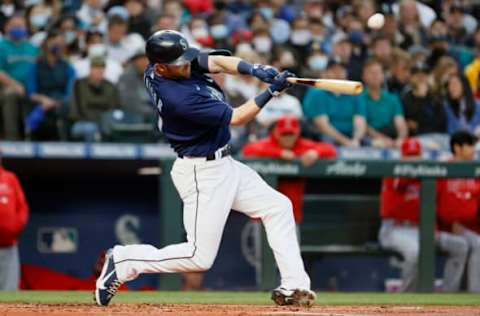 SEATTLE, WASHINGTON – OCTOBER 02: Mitch Haniger #17 of the Seattle Mariners hits a single during the first inning against the Los Angeles Angels at T-Mobile Park on October 02, 2021 in Seattle, Washington. (Photo by Steph Chambers/Getty Images)